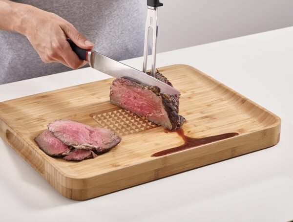 Joseph Joseph Cut & Carve Bamboo Cutting Board with Food Grip and Angled Surface Yellow Large - Image 7